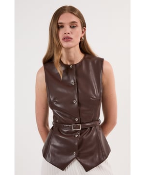 This Karen Millen faux leather waistcoat combines contemporary edge with classic tailoring for a standout piece in your wardrobe. The belted design cinches the waist, creating a structured silhouette that works wonderfully for various occasions. Style with pleated trousers for a sophisticated daytime look, or pair with slim-fit trousers and heels for evening drinks. This waistcoat transitions effortlessly from day to night, making it an essential addition to your collection that will serve you well for family gatherings and casual events alike.  Sleek faux leather waistcoat with a flattering slim fit silhouette Round neckline with front button fastening Matching belt with rectangular buckle Sleeveless design Subtle peplum-style hem creating a feminine shape
