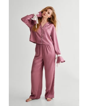 Sweet dreams. Feel luxe and relaxed in our satin pajama set, with handy button fastenings so you won't disturb your makeup or hair on the morning of the big day. Velvet ties add a sweet finishing touch to the look. A perfect choice for your bridal pajamas, or for lazy days and self care evenings. Satin Contrast Tie Cuff Pajama Shirt And Pants Set High Quality Satin Pajama Set Velvet Tie Detailing Button Up Pajama Shirt Comfortable High Waist Pajama Pants Model wears a size M (US size 6/UK size 10).