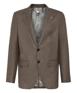 Chaqueta de dos botones confeccionada en lana. El escudo de la marca está bordado en el bolsillo de pecho. Dos bolsillos de solapa. El mismo escudo se aparece también en los botones. Abertura en el centro de la parte trasera. Forro interior. Corte: Super Slim.