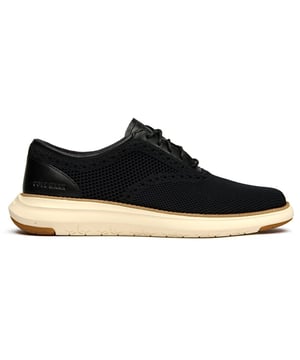 El Cole Haan Grand Remix Knit redefine la comodidad moderna con su innovadora tecnología de suela FlowerFoam que ofrece un excepcional acolchado con cada paso. Este elegante zapato negro con cordones combina un textil de punto transpirable con detalles de cuero refinado, creando un aspecto sofisticado que se adapta perfectamente de la oficina a la noche. La construcción liviana y la plantilla cómoda garantizan un uso prolongado durante todo el día sin sacrificar el estilo.