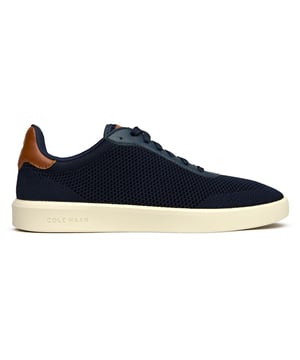 The Cole Haan Grand Court Daily Stitch brings athletic sophistication to your everyday rotation. Crafted with a breathable stitchlite upper in rich blue, these court-inspired trainers blend premium textile construction with serious comfort credentials. The padded collar and plush insole ensure all-day wearability, while the lightweight rubber sole delivers reliable traction whether you're courtside or city-bound. Modern comfort meets timeless style.