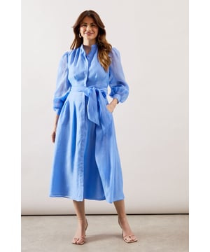 Elegant textured organza midi shirt dress with collarless neckline for a sophisticated silhouette
        Voluminous balloon sleeves with gathered cuffs create a dramatic yet refined look
        Flattering waist tie belt accentuates the figure while allowing for customised fit
        Practical side pockets discreetly integrated into the design
        Midi length offers versatility for both daytime and evening occasions
    
    This striking textured organza shirt dress combines contemporary elegance with timeless sophistication. The collarless design and button-through front create a clean, refined aesthetic, while the sumptuous balloon sleeves add a touch of drama to your ensemble. Cinch the included waist tie to create a beautifully defined silhouette that flatters all figures. Perfect for weddings and formal gatherings, style with delicate strappy heels as shown and statement earrings for a polished look. For race day events, complement with a fascinator and clutch bag. The versatile midi length works beautifully for graduation ceremonies or elegant garden parties. This Wallis piece transitions effortlessly from day to evening, making it a valuable addition to your occasion wardrobe that will serve you through multiple seasons with different accessories.