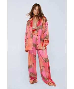 Wild thing. Our satin leopard pajamas are super luxurious, and will have you feeling refreshed come weekend lie-ins. Satin Leopard 3pc Shirt Bralette & Pants PJ Set PJ Shirt, Bralette, & Pants Set Satin Pajamas 3pc Set Long Sleeved Pajama Shirt Button Fastening Oversized Pajama Shirt Satin Bralette Satin Pajama Pants Comfortable High Waist Wide Leg Design Model wears a size M (US size 6/UK size 10).