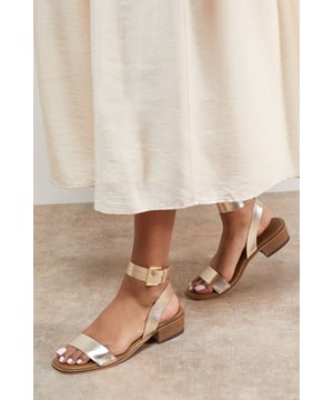 Genuine leather sandals with a comfortable mid-heel height of 5-6.5cm
        Minimalist design featuring a simple ankle strap with gold-tone buckle fastening
        Clean, open-toe silhouette perfect for showcasing pedicures
        Stacked block heel provides stability and all-day comfort
        Versatile design that pairs effortlessly with both casual and smart-casual outfits
    
    The Gracie Leather Sandals combine timeless style with everyday wearability. These versatile mid-heeled sandals feature a classic silhouette with a contemporary edge, making them a wardrobe essential for the warmer months. The ankle strap offers secure support whilst the modest block heel ensures comfort for extended wear. Style them with wide-leg denim and a broderie anglaise blouse for weekend brunches, or pair with a flowing midi dress for garden parties. These sandals transition seamlessly from day to evening, working beautifully with cropped trousers and a crisp shirt for casual office days. Their understated elegance makes them the perfect companion for summer holidays, city breaks, and casual gatherings where style and comfort are equally important.