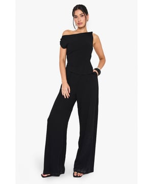Tall fit jumpsuit designed with distinctive twist-detail straps for added visual interest
        Chic one-shoulder neckline creates an asymmetric silhouette that draws attention
        Wide-leg trousers offer a flattering, flowing shape that enhances your height
        Practical side pockets add functionality without compromising on style
        Linen-look fabric provides a textured finish that's perfect for warmer weather
    
    Make a striking entrance in this sophisticated tall jumpsuit, designed with a contemporary twist-strap detail that adds a touch of drama to the one-shoulder neckline. The wide-leg silhouette creates a lengthening effect that's particularly flattering for taller frames, whilst the linen-look fabric offers a relaxed yet refined appearance. Style with strappy heels and statement jewellery for evening drinks, or dress down with flat sandals and a clutch for daytime gatherings. For cooler evenings, layer with a cropped jacket to maintain the jumpsuit's elegant proportions. This versatile piece transitions effortlessly from casual brunches to night-time soires-simply customise your accessories to suit the occasion. The clean lines and modern silhouette make this jumpsuit a standout choice for your going-out wardrobe.