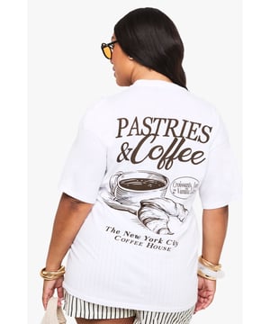 Oversized fit for ultimate comfort and relaxed styling
        Cotton fabric provides breathable all-day wear
        Trendy caf-inspired graphic print on the back
        Short sleeves with a classic crew neckline
        Versatile design that works with various bottoms
    
    This Plus Oversize T-Shirt with Kaftan-Print delivers effortless style with a touch of urban charm. The relaxed silhouette offers a flattering fit that drapes beautifully, making it perfect for casual outings. Style it as seen with your favourite blue denim jeans for a classic daytime look, or pair with cycling shorts and trainers for a contemporary twist. The distinctive caf-themed graphic adds character to this otherwise simple piece. Perfect for weekend brunches, casual coffee dates, or lounging at home with friends. Layer with an oversized cardigan and accessorise with statement jewellery when temperatures drop. This versatile t-shirt transitions seamlessly from day to night - simply swap your crossbody bag for a clutch and add some statement earrings for evening gatherings.