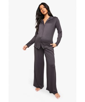 Comfortable maternity pyjama set
        Button-up shirt with collared neckline
        Long sleeves for added warmth
        Wide-leg trousers for unrestricted movement
        Soft, stretchy fabric to accommodate growing bump
    
    Embrace comfort and style during your pregnancy with this essential maternity pyjama set from boohoo. The versatile design features a classic button-up shirt with a collared neckline, perfect for lounging or sleeping. The long sleeves offer extra cosiness for those chilly nights, while the wide-leg trousers ensure maximum comfort as your body changes. The set's soft, stretchy fabric adapts to your growing bump, making it an ideal choice throughout your pregnancy journey. Whether you're having a relaxed night in or getting ready for bed, this pyjama set combines practicality with a touch of elegance, ensuring you feel confident and comfortable during this special time.