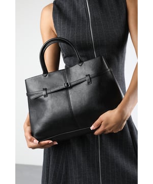 Upgrade your wardrobe with this Flores Luxury Structured Leather Tote Bag, perfect for work, travel, or everyday use. Crafted from premium materials, it features a sleek silhouette with a belt-style detail that adds a touch of refinement. Its spacious interior offers practicality without compromising on style. The minimalist design ensures it pairs effortlessly with both formal and casual outfits. Key Features: • Material: High-quality faux leather with a smooth matte finish • Dimensions: 36cm (L) x 24cm (H) x 14cm (W) • Fastening: Open top with structured design for easy access • Detail: Decorative wraparound belt strap with a central buckle accent