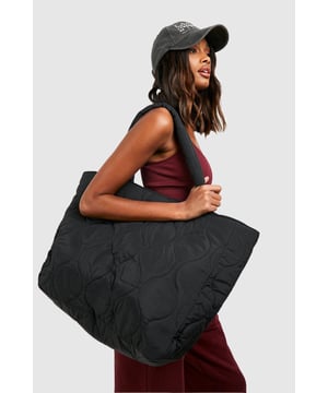 Oversized quilted design for maximum style impact
        Spacious interior perfect for everyday essentials
        Sturdy nylon construction ensures durability
        Versatile tote shape suitable for various occasions
        Interior zip pocket for secure storage of valuables
    
    Make a bold statement with this quilted oversized tote bag, a must-have accessory for the fashion-forward woman. Its generous proportions and eye-catching quilted pattern create a look that's both practical and chic. Whether you're heading to uni, meeting friends for brunch, or embarking on a weekend getaway, this bag has you covered. Style it with a crop top and high-waisted joggers for a casual day out, or pair it with a sleek midi dress and trainers for a more polished ensemble. The versatile design effortlessly transitions from day to night, making it the perfect companion for impromptu after-work drinks or casual family gatherings. With its roomy interior and secure zip pocket, you'll have plenty of space to organise your essentials while keeping your valuables safe. This tote is the ultimate blend of fashion and function, ready to complement your dynamic lifestyle.