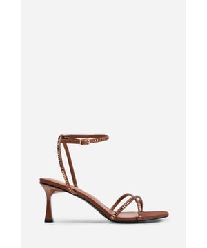 Introduce a touch of glamour to your footwear collection with our Sammi Square Toe Low Block Heel with Diamante Cross Over Strap Detail. These heels are the epitome of elegance and sophistication, making them the perfect finishing touch to any outfit, whether it's for a formal event, a night out, or a special occasion. Key Features: • Exquisite Design: The square toe silhouette of these high heels exudes a timeless appeal that never goes out of style. Enhanced by the diamante detail strap, these shoes are guaranteed to make heads turn. • High-Quality Construction: Crafted from premium materials, these high heels are designed to last. The high-quality construction ensures long-lasting durability while maintaining the comfort of your feet. • Versatile Addition: These are more than just your regular high heels. Make an entrance at any event. Be it a lavish wedding, a formal workplace event, or a casual outing with friends. The classy square-toe design with the decorative diamante detail is versatile enough to pair with a variety of outfits and are your perfect partner for a chic update to your look. Specifications: • Closure: Ankle strap with buckle. • Heel Height: 3.3' (8.3cm) approx Invest in our Sammi Square Toe Low Block Heel with Diamante Cross Over Strap Detail and bring that extra touch of elegance and sophistication to your wardrobe. They speak loud and clear of luxury and style – a piece worth showcasing!
