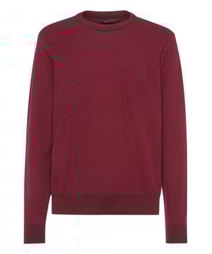 Explore nuevas formas de expresar la elegancia con las propuestas de esta temporada. Como este jersey de lana merina con cuello redondo. Fíjese en los detalles.   Punto de canalé diagonal de lana merina de calibre 7/12.   Escudo bordado en el pecho izquierdo   Monograma bordado en una presilla de ante cosida en el canesú   Dobladillo de punto de canalé