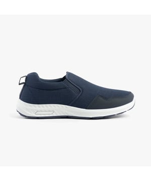 These wide-fit men's trainers feature a textile upper and lining with a rubber sole, offering comfort and breathability. Ideal for casual wear with a low-top design and slip-on closure
