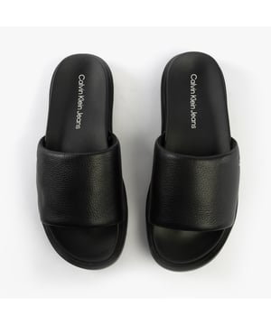 These men's slide sandals feature a leather upper, synthetic lining, and EVA sole for lightweight comfort. Ideal for casual wear with a flat heel and slip-on design