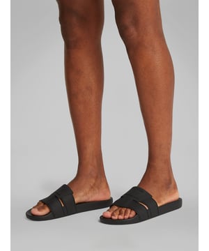 These men's slip-on sliders feature a synthetic upper and lining with a rubber sole, offering comfort and lightweight wear for casual occasions