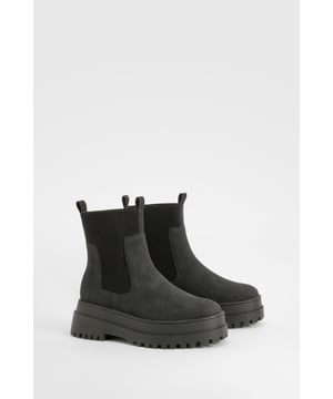 Wide fit Chelsea boots with chunky sole
        Elastic side panels for easy slip-on
        Nubuck upper for a soft, velvety texture
        Low heel height between 2.5 and 4.5cm
        Thick, treaded outsole for enhanced grip
    
    Step out in style and comfort with these trendy wide fit Chelsea boots from Boohoo. The chunky silhouette and robust sole make a bold statement, perfect for the fashion-forward woman who values both style and practicality. The elastic side panels ensure a snug fit and easy on-off, while the nubuck upper adds a touch of luxury to your casual ensemble. Pair these versatile boots with skinny jeans and an oversized jumper for a laid-back weekend look, or team them with a flowy midi dress and leather jacket for a chic autumn outfit. Ideal for family gatherings, casual outings, or even a relaxed day at the office, these boots offer the perfect blend of comfort and urban edge. The low heel provides just enough lift without compromising on all-day wearability, making them a go-to choice for the busy woman on the move.