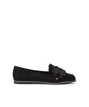 This Mable Bow Loafer is crafted from a black microsuede. There is a black fabric bow detail on the front of the vamp. There is a gold tone detail around the sole.