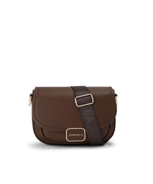 This Boxy Saddle Bag is crafted from a textured dark brown leather alternative. The curved front flap is adorned with a gold trimmed branded plate. 17cm (H), 22cm (L), 5.5cm (D). Strap length: 119cm. Woven cross body strap. Magnetic snap closure under flap. Interior front pocket. Can fit phones up to 7inches. Black interior lining.