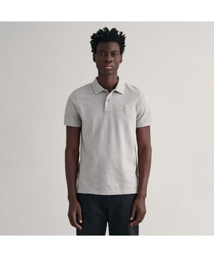 Crafted from 100% cotton in a piqué texture  this GANT polo shirt is cut for a regular fit. It is designed with short sleeves  a flat knit collar and a two button placket. This polo shirt features a GANT shield graphic with a vintage-inspired touch embroidered at the chest in a shiny  tonal thread.By choosing our cotton products  you’re supporting GANT's investment in Better Cotton’s mission. This product is sourced via a system of mass balance and therefore may not contain Better Cotton. Read more on bettercotton.org-massbalance.