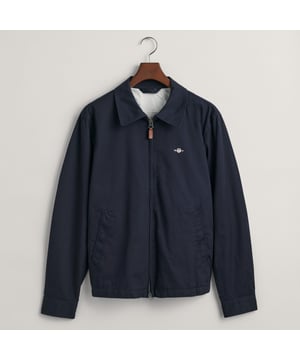 The Cotton Windcheater is a timeless GANT classic that has been a staple for years. It comes in a regular fit with a partly elasticated hem  giving it a fitted silhouette  and sits just above the hips. The jacket is half-lined and features a front zip closure  slanted side welt pockets  and two interior jetted pockets. It's adorned with an embroidered Archive Shield graphic on the chest and includes a GANT branded locker loop at the back.