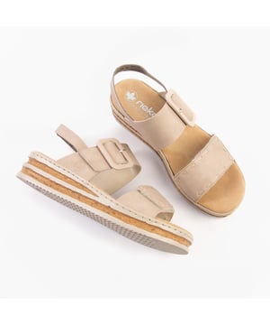 These women's wedge sandals feature a synthetic upper, breathable textile lining, and a RIRICON sole. Designed for comfort and casual wear with buckle and touch fasten closures