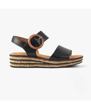 These women's open-toe wedge sandals feature a leather upper, textile lining, and rubber sole for comfort and lightweight wear, perfect for casual occasions