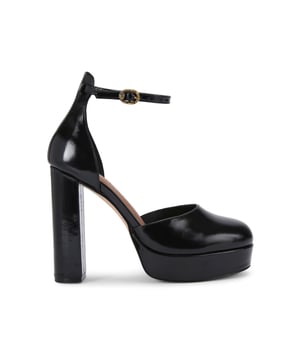 The Kurt Geiger Shoreditch Platform court heel features a black leather upper with rounded toe. The ankle is fastened with antiqued brass eagle head buckle. Heel height: 11.5cm.