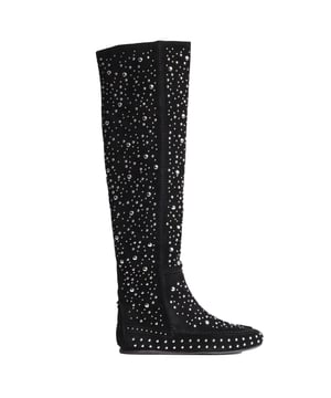 Zadig & Voltaire studded knee-high boots – Bold style with a bohemian spirit.\n\n Zadig & Voltaire's knee-high boots reinterpret boho style with a striking and distinctive design. Crafted from high-quality suede, these boots combine the warmth of natural materials with the shine of hundreds of metallic studs adorning their surfaces.\n\n The high shaft fits elegantly over the leg, while the flat, moccasin-style design provides comfort without compromising on style. The side closure with an interior zipper makes it easy to put on, and the structured silhouette visually streamlines the outfit.\n\n Details:\n - Type of footwear: Flat high boot.\n - Outer material: Soft suede.\n - Inner lining: Textile.\n - Details: Metal stud applications throughout the boot.\n - Closure: Side interior zipper.\n - Sole: Thin and flexible rubber.\n - Height: Knee-length (can be worn gathered thanks to its flexibility).\n - They have a dust bag.\n\n With these boots, Zadig & Voltaire captures the perfect balance between rebellion and sophistication. A bold choice for women who make a statement with their own style.\n Composition: Exterior: Suede; Interior: Leather; Sole: Synthetic\n Care:\nClean with a soft, dry cloth.\n Avoid contact with water, perfumes or abrasive products.\n Store in a dry and ventilated place.