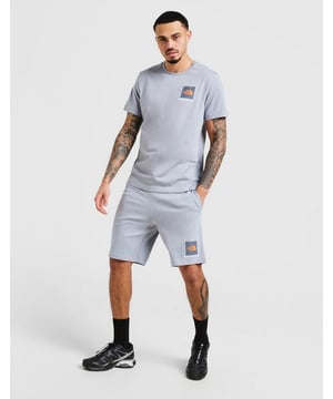 Refresh your off-duty rotation with this laid-back co-ord set from The North Face. Featuring the Small Box T-Shirt and Shorts, this matching combo in Tradewinds Grey with Orange accents blends everyday comfort with clean, minimalist branding—perfect for relaxed days, travel, or street-ready layering. T-Shirt Details: Material: 100% soft cotton for lightweight, breathable comfort Fit: Regular fit with a classic crew neckline and short sleeves—ideal for layering or wearing solo Design: Finished with a Small Box logo on the chest and the signature Half Dome logo on the reverse shoulder for a subtle yet iconic touch Shorts Details: Material: Soft fleece blend (80% Cotton / 20% Polyester) for a cosy, durable feel Fit: Regular cut with a relaxed silhouette that lands just above the knee Waistband: Elasticated with an internal drawcord for adjustable comfort Pockets: Two open side pockets for daily essentials Design: Topped off with a matching Small Box logo above the hem to complete the coordinated look Care Instructions: Tee: Machine wash cold. Tumble dry low. Do not iron print Shorts: Machine wash as per label. Air dry or tumble dry low for best results