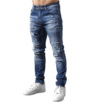 Upgrade your denim game with the Enzo Milano slim fit Jeans for men, crafted for style and comfort. Featuring bold ripped and repaired detailing, these denim jeans deliver a rugged, contemporary look accentuated by unique paint splash accents. The tapered leg creates a modern silhouette, while premium stretch fabric ensures ease of movement and a perfect fit. A concealed zip fly fastening adds a clean finish, complemented by a classic 5-pocket design for everyday practicality. Finished with the signature Enzo Milano PU branded label at the back, these denim trousers embody high-quality craftsmanship and distinctive urban flair.