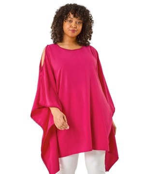 Curve Bobble Trim Hanky Hem Top from Roman. Embrace a touch of elegance with our charming hanky hem top. Crafted from a light and airy chiffon fabric, this top features a flattering round neckline, flowy hemline detail and playful pom pom bobble trims for extra flair. Designed with short sleeves and a breezy tunic shape, this top is perfect for a sophisticated evening out. Team with tailored trousers and heels for a classy and stylish look that will turn heads effortlessly!
