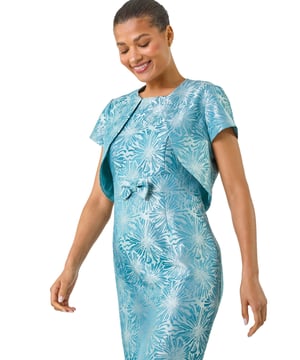 Jacquard Occasion Jacket from Roman.  Complete the look with matching 14765286 dress.  This jacquard occasion jacket features elegant short sleeves and a full open style, making it a versatile addition to your wardrobe. Perfect for pairing with the matching dress, it adds a touch of sophistication to any occasion. Complete the look with heels for a polished, chic outfit.
