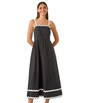 Contrast Ric Rac Midi Dress from Roman. Add a fun and playful touch to your Summer wardrobe with this chic ric rac midi dress. Featuring cute strappy sleeves and a midi length, this dress is adorned with a contrasting ric rac design that adds a whimsical charm. Perfect for sunny days, style this dress with sandals and a denim jacket for a laid-back yet stylish look that is perfect for any casual outing!