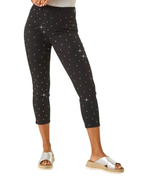 Embellished Cropped Stretch Jeggings from Roman. Get ready to sparkle in these cropped jeggings this Spring Summer! Featuring functional belt loops and a flattering shape, these denim jeggings are adorned with beautiful embellished details. Cut from a soft, stretch cotton fabric, they finish at a stylish cropped length. Pair with a white blouse and wedge sandals for a trendy outfit that effortlessly transitions from day to night.