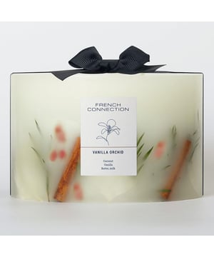 The French Connection Botanical Collection Vanilla Orchid Candle offers a warm, comforting fragrance that blends the creamy richness of vanilla with the soft, floral notes of orchid. This candle envelops your space in a cosy, inviting aroma, ideal for relaxation and unwinding. The subtle sweetness of vanilla combined with the gentle elegance of orchid creates a refined yet comforting scent that lingers delicately in the air. Housed in a sleek, stylish container, this candle serves as both an elegant decor piece and a luxurious, calming addition to any room.