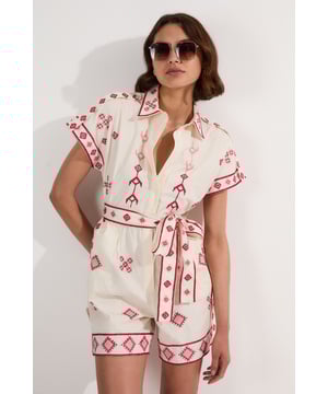This Karen Millen embroidered playsuit offers effortless sophistication for your daytime wardrobe. The striking geometric embroidery creates visual interest against the cotton base, whilst the collared neckline adds a touch of refinement. The self-tie belt allows you to customise the fit to your preference, creating a flattering silhouette. Perfect for family gatherings or casual coffee dates, this versatile piece transitions seamlessly from day to evening when accessorised with espadrille wedges and a woven clutch. The cotton fabric ensures you'll stay cool and comfortable, making this playsuit an essential addition to your warm-weather collection.  Crafted from pure cotton Intricate embroidered pattern Collared neckline with short sleeves Self-tie belt to define and flatter the waistline