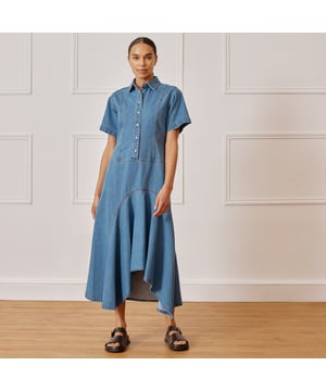 Elevate your denim game with our Dipped Hem Denim Dress. This vintage washed shirt dress boasts a fitted bodice, flattering dipped hem skirt, and practical features such as short sleeves, a collar, and popper fastening. Perfect for effortless style and ease.