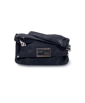VINTAGE, RRP AS NEW
A true icon from the golden era of logomania, this Fendi messenger bag perfectly channels the spirit of early 2000s design - practical, bold, and effortlessly stylish.  Crafted from Fendi's signature black small FF monogram canvas and trimmed with smooth black leather, it's a standout piece that speaks volumes without saying a word. The front flap pocket is secured with a magnetic button closure and adorned with a striking silver-tone FF logo, a timeless emblem of the house's unmistakable aesthetic.  A secure upper zip closure keeps your belongings safe, while the black canvas-lined interior offers one open pocket for organization. Inside, you'll also find the 'FENDI - Made in Italy' tag and the ity serial number - quiet but essential Condition Rating: B - VERY GOOD CONDITIONCondition Details: Gently used. Some normal wear of use on canvas due to normal use. Some wear of use on the internal lining(light fading) . Please check the photos carefully and ask if you need to know more details or if you have any doubts.Measurements (cm):Depth: 7.6Height: 12.7Length: 22.9Other Details: Dustbag? NoKeys? NoBox? No Measurments:  width: 76 mm length: 229 mm height: 127 mm