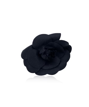 VINTAGE, RRP AS NEW
Elegant and unmistakably classic, this vintage Chanel Camellia brooch captures the essence of the house's refined femininity. The Camellia - a symbol of Chanel's enduring muse - blooms here in soft black silk, its petals gently layered to evoke quiet sophistication and grace.  With a generous diameter of 3.5 inches (8.9 cm), this statement piece is secured with a traditional safety pin closure. The reverse bears the iconic 'CHANEL - CC - Made in France' oval tab, marking its ity and Parisian heritage. A quintessential vintage treasure, perfect for adorning lapels, scarves, or bags with timeless allure. Condition Rating: A - EXCELLENTCondition Details: Gently used. Chanel box included. Please check the photos carefully and ask if you need to know more details or if you have any doubts.  Box?: ?: Yes