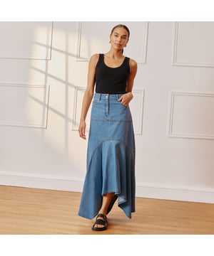 Crafted in a vintage wash denim, this skirt is cut in a classic five pocket jean design. Featuring a dropped waist and a draped skirt that flatters with a dipped hemline.