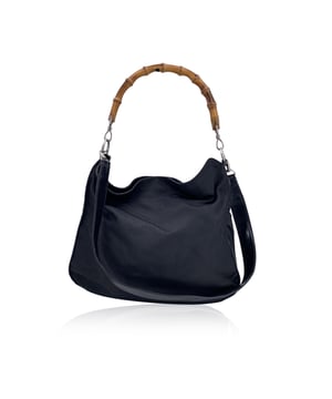 Empfohlener Verkaufspreis
Diese wunderschöne Hobo-Tasche von Gucci ist aus glattem, schwarzem Nylon-Canvas gefertigt und verfügt über den markentypischen Bambus-Schlaufengriff, der ihr eine raffinierte und dennoch moderne Ästhetik verleiht. Die Tasche wird für einfachen Zugriff mit einem oberen Magnetknopf geschlossen und ist mit goldfarbenen Metallbeschlägen akzentuiert, die einen Hauch von Eleganz verleihen. Innen ist sie mit schwarzem Stoff gefüttert und verfügt über eine praktische seitliche Reißverschlusstasche für wichtige Dinge. Ein abnehmbarer Schultergurt ermöglicht vielseitiges Styling. Im Inneren befindet sich außerdem ein Lederetikett mit der Prägung „GUCCI – Made in Italy“, auf der Rückseite ist die Seriennummer eingeprägt – ein Zeichen für Guccis berühmte Handwerkskunst. Zustandsbewertung: B – SEHR GUTER ZUSTAND. Zustandsdetails: Wenig verwendet. Einige Gebrauchsspuren an den unteren Ecken. Einige normale Gebrauchsspuren am oberen Rand. Bitte sehen Sie sich die Fotos sorgfältig an und fragen Sie nach, wenn Sie weitere Details benötigen oder Fragen haben. Maße (cm): Tiefe: 7,6 Höhe: 30,5 Länge: 39,4 Weitere Details: Staubbeutel? Keine Schlüssel? Keine Box? Nein Maße: Breite: 76 mm Länge: 394 mm Höhe: 305 mm