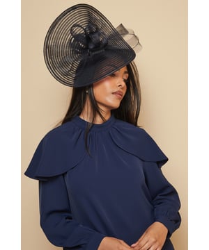 Striking loop upturn disc design creates a dramatic silhouette perfect for formal occasions
        Elegant woven construction with delicate ribbed detailing for added texture and dimension
        Versatile side positioning allows for multiple styling options to complement various hairstyles
        Lightweight and comfortable design ensures all-day wearability at extended events
        Sophisticated bow accent adds a refined finishing touch to this statement piece
    
    Make a captivating entrance at your next special event with this Loop Upturn Disc Fascinator from Wallis. This sophisticated headpiece showcases an architectural silhouette that frames the face beautifully while creating a striking profile. The fascinator's side positioning works wonderfully with both updos and flowing locks, as demonstrated by our model who pairs it with sleek, straight hair for maximum impact. Perfect for weddings, race days and formal garden parties, this fascinator adds instant glamour to occasion wear. Style with a fitted dress featuring a high neckline as shown, or pair with an elegant jumpsuit for a contemporary twist. The disc design offers just the right amount of drama without overwhelming your ensemble, allowing you to radiate confidence and sophistication throughout your special day.