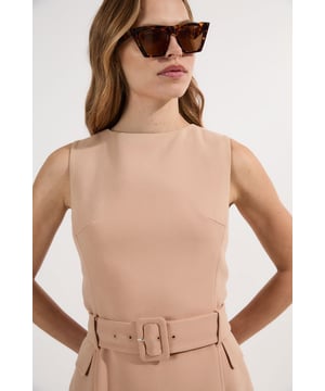 This Compact Essential Belted Tailored Midi Dress from Karen Millen presents a masterclass in refined daywear. The clean lines and structured silhouette create a polished look that transitions effortlessly from office to weekend engagements. For daytime gatherings, pair with pointed ballet flats and a structured tote bag for an ensemble that conveys quiet confidence. The versatile midi length works for family lunches, gallery visits, or casual networking events. The belted waist detail allows for customised styling - wear cinched for a defined silhouette or remove for a more relaxed approach to tailored dressing.  Tailored midi dress with a round neckline Matching fabric belt with statement buckle Sleeveless design Practical side pockets Refined back vent