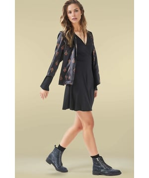 We love the bohemian edge that trumpet sleeves lend to an outfit, emphasised with this cute mini dress. In a black ribbed jersey, it comes in a flattering wrap-style with a skater skirt. Team with black boots for a smart casual look.
Sizing is slightly small
Length: 33" Shoulder to Hem approx.