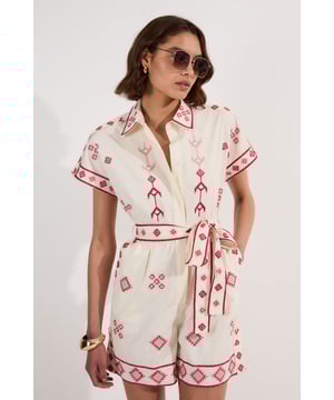 This eye-catching embroidered playsuit from Karen Millen's Petite collection presents a perfect blend of comfort and style for warm-weather occasions. The distinctive geometric pattern creates a striking visual interest whilst the collared neckline adds a touch of sophistication. The self-tie belt allows you to customise the fit to your preference, creating a flattering silhouette. Perfect for garden parties, weekend brunches or holiday excursions, this versatile piece can be dressed down with trainers and a denim jacket for casual outings, or paired with flat sandals and a woven bag for a relaxed yet put-together ensemble. The cotton fabric ensures you'll stay comfortable throughout the day whilst the unique embroidery ensures you'll stand out from the crowd.  Intricate embroidered geometric pattern Collared neckline with button-through front design Short sleeves with embroidered trim detailing Self-tie fabric belt to define the waist Cotton woven fabric