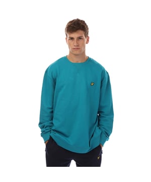 Mens Lyle And Scott Crewneck Sweatshirt in blue.- Ribbed crewneck.- Ribbed cuffs and hem.- Retro-inspired triangle stitch detail at the neckline.- Golden eagle embroidered logo badge stitched to the chest.- Regular fit.- 100% Organic Cotton.- Ref: ML424VOGXX293