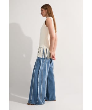 These statement Petite Denim Tassel Detail Wide Leg Jeans from Karen Millen present a bold take on casual denim. The dramatic wide-leg silhouette creates a flowing, relaxed shape that moves with every step, whilst the vertical frayed stripes elongate the frame. The regular fit ensures these jeans remain comfortable for all-day wear, making them perfect for weekend brunches, casual shopping trips or relaxed gatherings with friends. These versatile jeans will quickly become your go-to for effortlessly stylish daywear.  Striking vertical tassel detailing Ultra-wide leg silhouette Regular fit design Distinctive frayed vertical stripes High-rise waistband