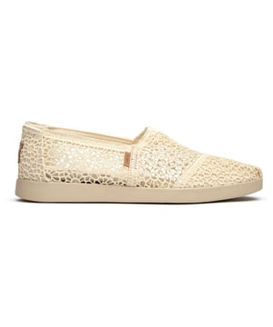 These canvas espadrilles blend TOMS' signature comfort with elevated style that works from weekend coffee runs to evening strolls. The natural canvas upper brings an effortless, lived-in feel while the durable rubber sole provides reliable grip and cushioning. Built on the beloved Alpargata silhouette, they're the kind of versatile flats that become your go-to for practically everything.
