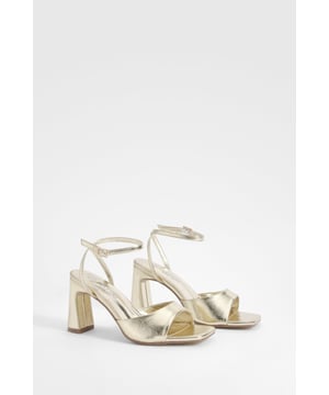 Chic wide fit heels with a high 7-9cm block heel
        Elegant square toe design for a modern touch
        Adjustable ankle strap with buckle closure
        Versatile platform sole for added comfort
        Sleek synthetic leather upper for a polished look
    
    Step out in style with these stunning wide fit heels from Boohoo. Perfect for the fashion-forward woman who demands both comfort and trend-setting style, these heels are designed to turn heads at any social gathering. The chunky block heel, measuring between 7-9cm, offers stability without compromising on height, while the wide fit ensures all-night comfort for those marathon nights out. Pair these beauties with your favourite little black dress for a classic club look, or dress them down with cropped jeans and a statement top for drinks with the girls. The neutral tone makes them incredibly versatile, allowing you to customise your look for any occasion. Whether you're dancing the night away or making a lasting impression at a cocktail party, these heels will keep you looking fabulous from dusk till dawn.