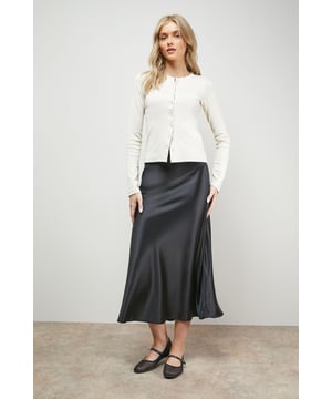 Elegant bias cut design creates a flattering drape that skims the silhouette
        Lustrous satin fabric catches the light beautifully with every movement
        Midi length hits below the knee for a contemporary, versatile profile
        Subtle side slit adds a touch of feminine flair and ease of movement
        Smooth waistband sits comfortably at the natural waist
    
    This Oasis bias cut satin midi skirt showcases the perfect balance of casual sophistication and everyday wearability. The diagonal cutting technique creates a gorgeous drape that flows with your body rather than against it, whilst the glossy satin fabric adds a touch of luxury to your daytime wardrobe. Style with a simple vest top and flat loafers as seen on our model for an effortlessly chic weekend look, or pair with a soft knit jumper and trainers for coffee dates and family gatherings. The versatile midi length works beautifully for various casual occasions, from shopping trips to informal lunches. Complete your ensemble with a woven handbag and delicate jewellery for a feminine finishing touch that reflects the pretty, girly aesthetic Oasis is known for.