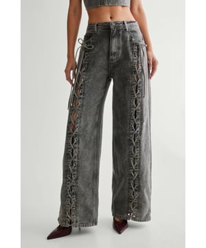 Striking lace-up detail along the sides
        High-waisted design for a flattering silhouette
        Wide-leg cut for a trendy, relaxed look
        Cropped top with square neckline and thick straps
        Back lace-up closure on the top for adjustable fit
    
    Make a bold statement with these eye-catching jeans from NastyGal. The standout lace-up detail running along the sides adds a daring edge to your casual ensemble. Pair with the matching cropped top for a coordinated look that's sure to turn heads. The high-waisted, wide-leg cut is perfect for creating a long, lean silhouette. Style with chunky trainers for a laid-back vibe, or dress up with heeled boots for evening drinks. These versatile jeans are ideal for family gatherings, brunches with friends, or casual Friday at the office. The denim fabric offers comfort and durability, making these jeans a wardrobe staple you'll reach for time and time again.